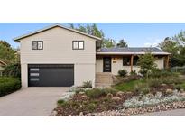 Charming split-level home featuring a modern two-car garage and beautifully landscaped front yard at 1931 Foothills Rd, Golden, CO 80401
