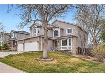 Charming two-story home with a landscaped front yard and a two-car garage in a suburban setting at 6470 S Oak Ct, Littleton, CO 80127