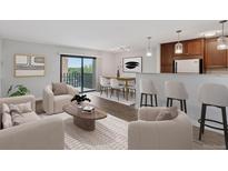 Open-concept living room with modern furnishings and a sliding glass door to a balcony with views at 480 S Marion Pkwy # 802, Denver, CO 80209