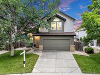 Charming two-story home with a well-maintained lawn and attached two-car garage, set against a colorful evening sky at 4112 Brandon Ave, Broomfield, CO 80020