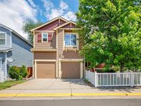 Charming two-story home with a two-car garage and well-manicured landscaping, exuding curb appeal at 1288 S Beeler Ct, Denver, CO 80247