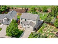 Beautiful aerial view of home showcasing lush backyard and manicured landscaping at 19410 E Ithaca Pl, Aurora, CO 80013