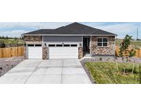 Beautiful single-Gathering home featuring a three-car garage and stone and gray siding at 13488 Wabash St, Thornton, CO 80602