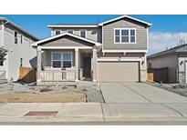 Charming two-story home with a covered porch and a two-car garage, number 220 at 220 Lark Sparrow Way, Bennett, CO 80102