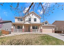 Inviting home with a welcoming front porch, classic design, and neutral color scheme at 10933 E 115Th Pl, Commerce City, CO 80640