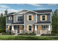 Charming two-story townhome with stone accents, shuttered windows and a manicured front lawn at 20711 E 57Th Ave, Aurora, CO 80019