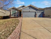 Two-car garage and nicely landscaped front yard at 5750 Cheetah Chase, Lone Tree, CO 80124