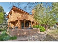Exterior view of home featuring a brick patio and beautiful landscaping at 9400 E Iliff Ave # 181, Denver, CO 80231