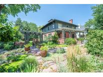 Beautiful two-story home boasts professionally landscaped yard, pergola, brickwork and lush greenery at 171 N Franklin St, Denver, CO 80218