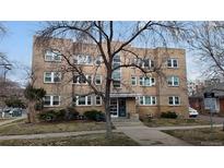 Apartment building exterior features brick facade, classic design and landscaping at 505 N Logan St # 14, Denver, CO 80203