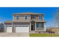 Charming two-story home boasts a three-car garage, covered porch, and inviting curb appeal at 1898 Westport Ave, Berthoud, CO 80513
