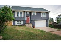 Charming two-story home featuring a well-maintained front yard and a two-car garage at 103 Aurelia St, Palmer Lake, CO 80133