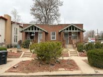 Charming brick duplex featuring individual entrances and a well-maintained front yard at 4159 Wyandot St, Denver, CO 80211