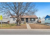 Charming single-story home featuring a welcoming front porch and well-maintained lawn at 1770 S Dahlia St, Denver, CO 80222