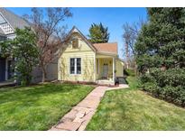 Charming yellow home features a well-maintained lawn, stone walkway, and inviting curb appeal at 3333 W Hayward Pl, Denver, CO 80211