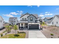 Charming two-story home with a well-maintained front yard and a two-car garage at 1168 Elbridge Dr, Elizabeth, CO 80107