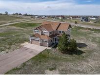 Areal view of a charming home with a spacious yard in a peaceful neighborhood at 40900 Red Fox Cir, Elizabeth, CO 80107