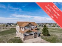 Charming two-story home featuring a two-car garage, well-maintained landscaping, and a large open yard space at 40900 Red Fox Cir, Elizabeth, CO 80107
