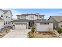 Beautiful home with a two-car garage, neutral exterior, and well-maintained landscaping at 7077 Copper Sky Cir, Castle Pines, CO 80108