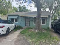 Charming bungalow-style home with a large tree in the front yard at 260 Sheridan Blvd, Denver, CO 80226