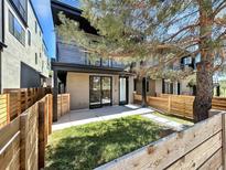 Modern townhouse with a well-manicured lawn, fenced for privacy and curb appeal at 1238 N Tennyson St, Denver, CO 80204
