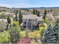 Expansive backyard featuring a multi-tiered deck and lush landscaping, perfect for outdoor living at 3266 Coyote Hills Way, Castle Rock, CO 80109