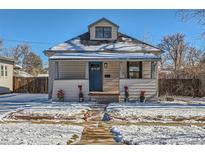 Charming bungalow with a newly renovated exterior and snowy front yard at 2222 Fenton St, Edgewater, CO 80214