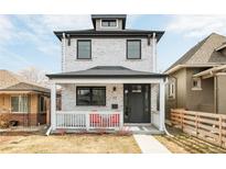 Charming two-story home with a covered front porch and modern gray and white brick at 3322 N Columbine St, Denver, CO 80205