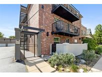 Charming brick apartment building featuring inviting balconies and a secure gated entrance at 529 N Washington St # 304, Denver, CO 80203