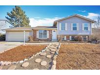 Charming two-story home featuring a well-manicured front yard and attached two car garage at 17869 E Gunnison Pl, Aurora, CO 80017