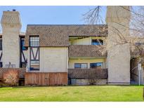Three-story condo with brick facade, private patios, and well-maintained landscaping at 7201 E Quincy Ave # 103, Denver, CO 80237