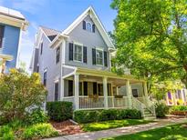 Charming two-story home featuring a welcoming front porch, manicured landscaping, and classic architectural details at 7899 E 28Th Pl, Denver, CO 80238