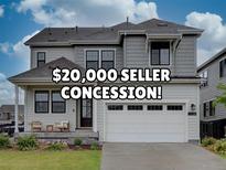 Charming two-story home with a two-car garage and inviting front porch at 11246 Bellsong Ln, Littleton, CO 80125