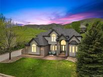 Stunning two-story home with lush front lawn, manicured landscaping, and mountain views at 10 Summit Ash, Littleton, CO 80127