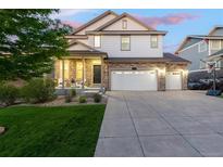 Beautiful two-story home with a well-maintained lawn, stone accents, three car garage and covered porch at 6236 S Millbrook Way, Aurora, CO 80016