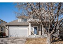 Charming two-story home with attached two-car garage and well-maintained lawn at 11499 Kenton St, Commerce City, CO 80640