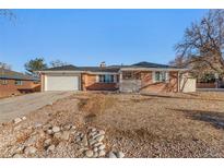 Brick ranch home with a landscaped yard at 406 Titan Ct, Aurora, CO 80011