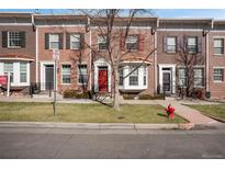 Brick townhomes with colorful shutters, manicured lawns, and a charming tree-lined street at 4305 W 118Th Pl, Westminster, CO 80031