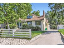 Charming home with a white picket fence, mature trees, and a long driveway at 3246 W 53Rd Ave, Denver, CO 80221