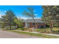 Charming single-story brick home with well-manicured landscaping and mature trees enhancing curb appeal at 295 E Amherst Ave, Englewood, CO 80113