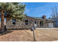 Charming stone-accented ranch-style home featuring a cozy brick chimney and one-car attached garage at 2260 S Lewiston St, Aurora, CO 80013
