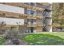 Exterior view of apartments, featuring multiple balconies, stairwell, and well-maintained green spaces at 384 S Ironton St # 201, Aurora, CO 80012