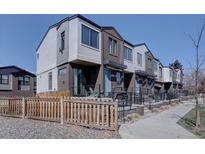 Modern townhomes showcase a mix of brick and siding with individual front patios and well-maintained landscaping at 5469 S Curtice St # L, Littleton, CO 80120