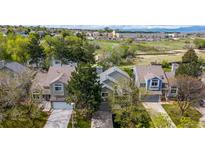 Charming townhouse featuring a well-maintained lawn, attached garages, and mature trees in a serene neighborhood at 11427 King Way, Westminster, CO 80031