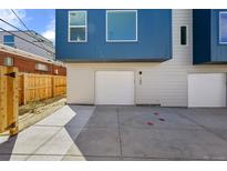 Modern two-story home featuring a one-car garage and concrete driveway with a wooden fence on the side at 2140 S Ash St # 105, Denver, CO 80222