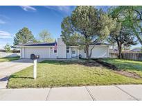 Charming single-story home with a well-maintained lawn, mature tree, and an attached two-car garage at 3561 W 131St Ave, Broomfield, CO 80020