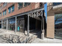 Modern brick building featuring sleek architectural details and prominent street-facing signage at 4144 Tennyson St # 212, Denver, CO 80212