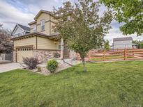 Charming two-story home with a well-maintained lawn and mature landscaping creates great curb appeal at 4862 S Piccadilly Ct, Aurora, CO 80015