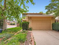 Inviting home featuring an attached two-car garage and beautifully maintained front yard landscaping at 4032 S Atchison Way, Aurora, CO 80014
