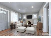 Inviting living room with fireplace, hardwood floors, and lots of natural light at 3336 N Saint Paul St, Denver, CO 80205
